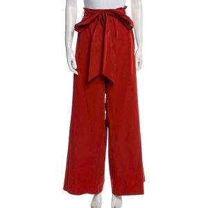 Wide leg pants, deep red color.